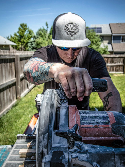 woman cutting tile