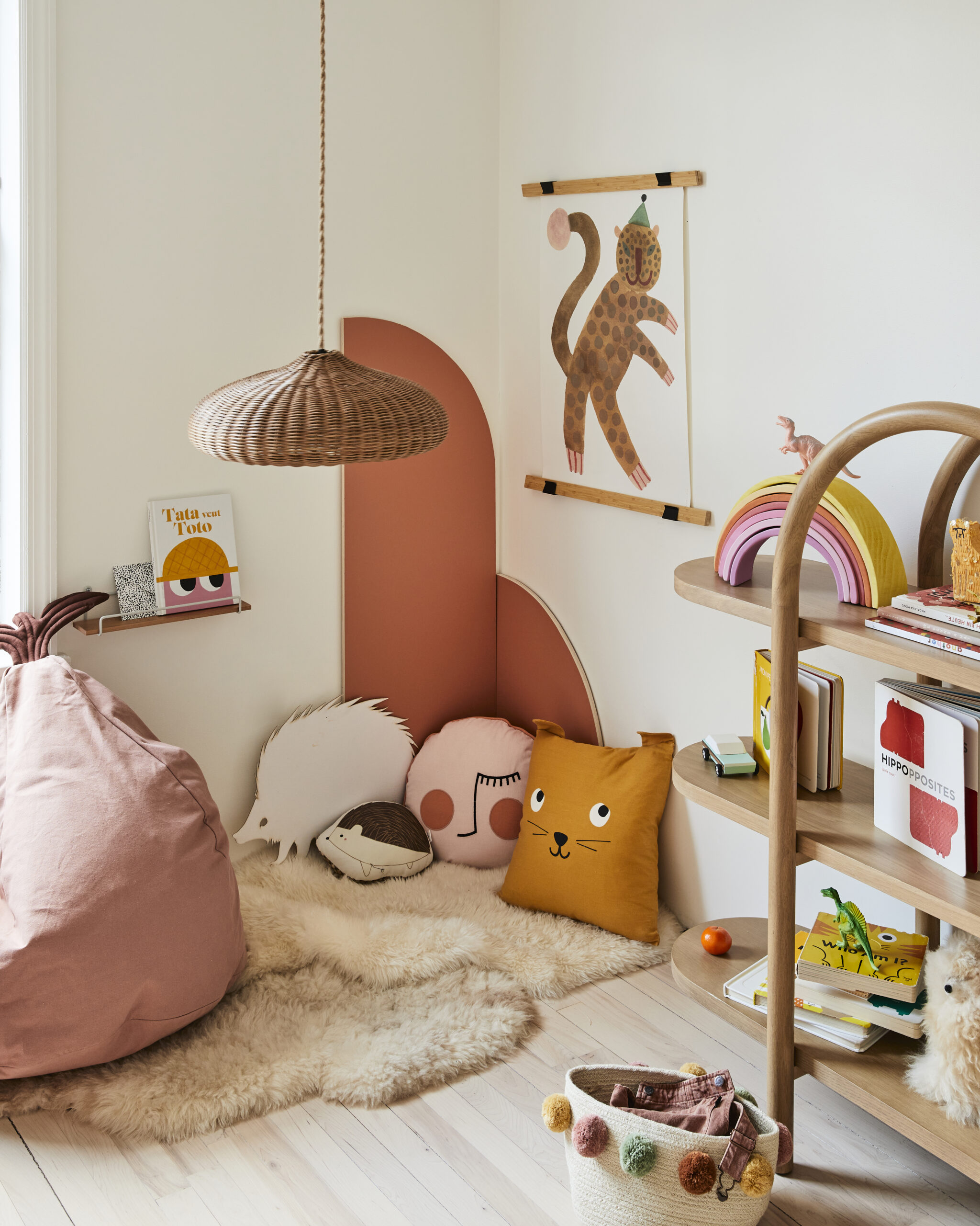 floor reading nook with orange arched panels and sheepskins