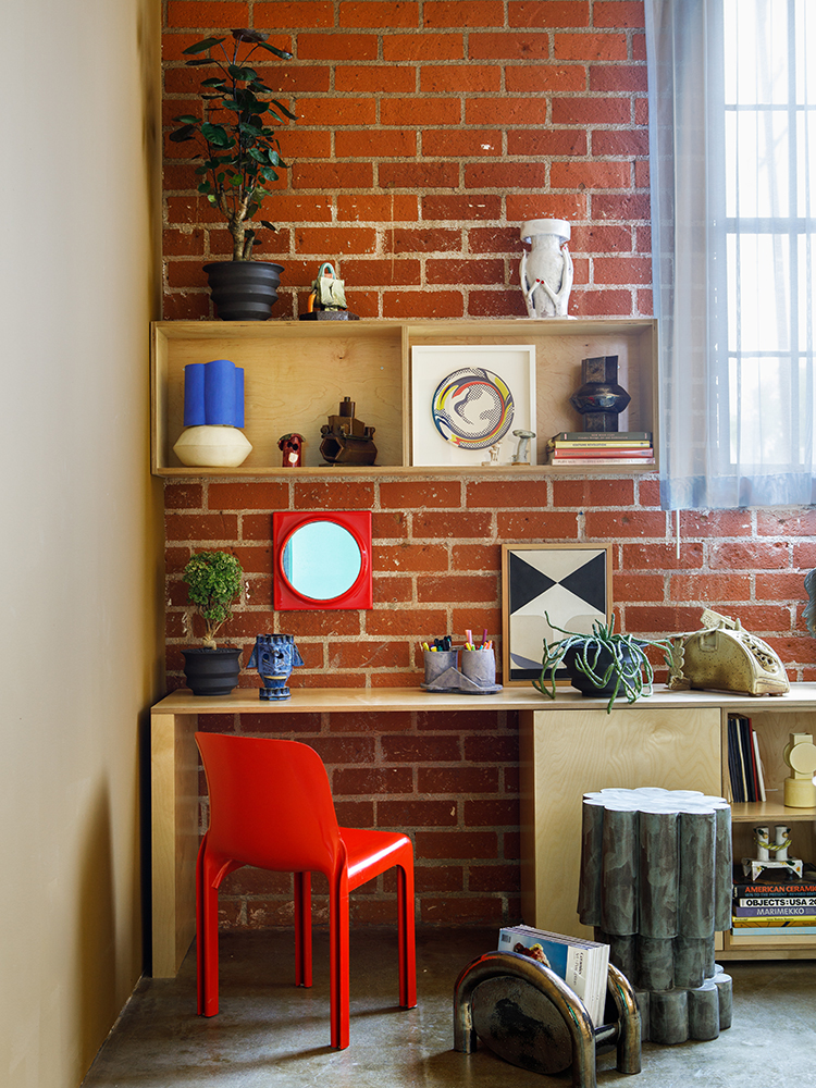 Desk against a brick wall