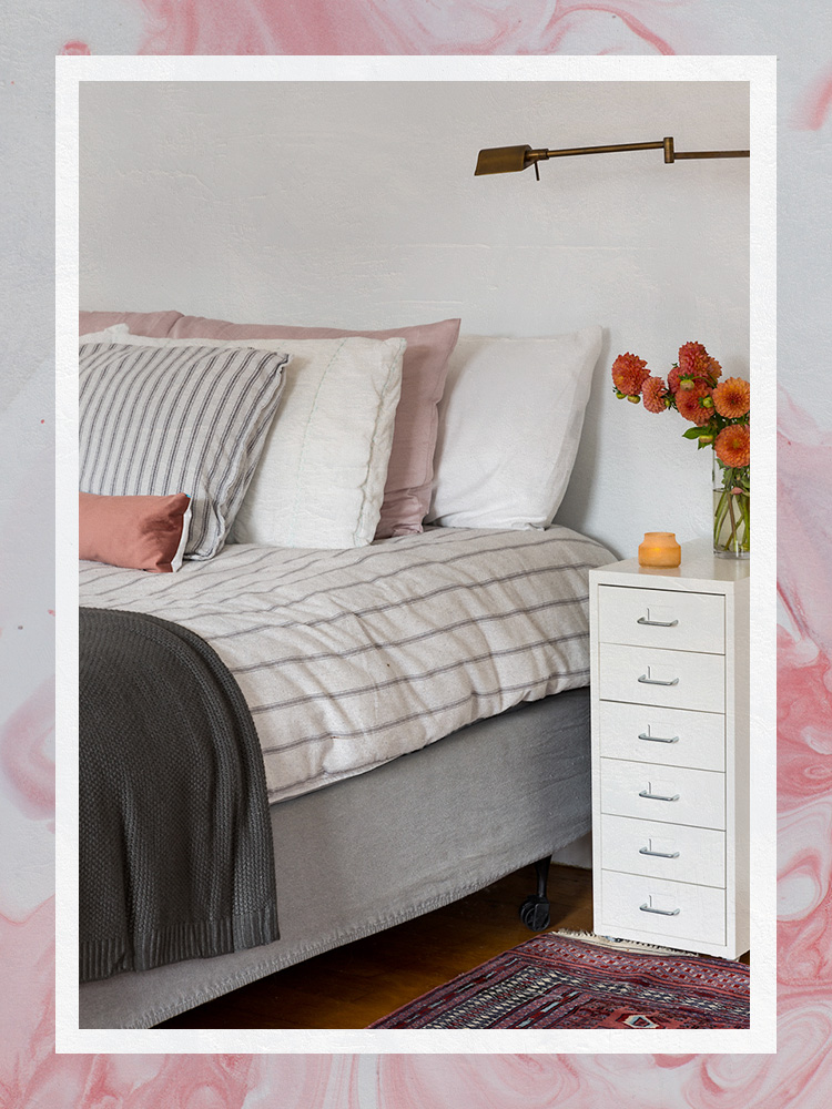 Pillows on a fluffy bed with a striped duvet