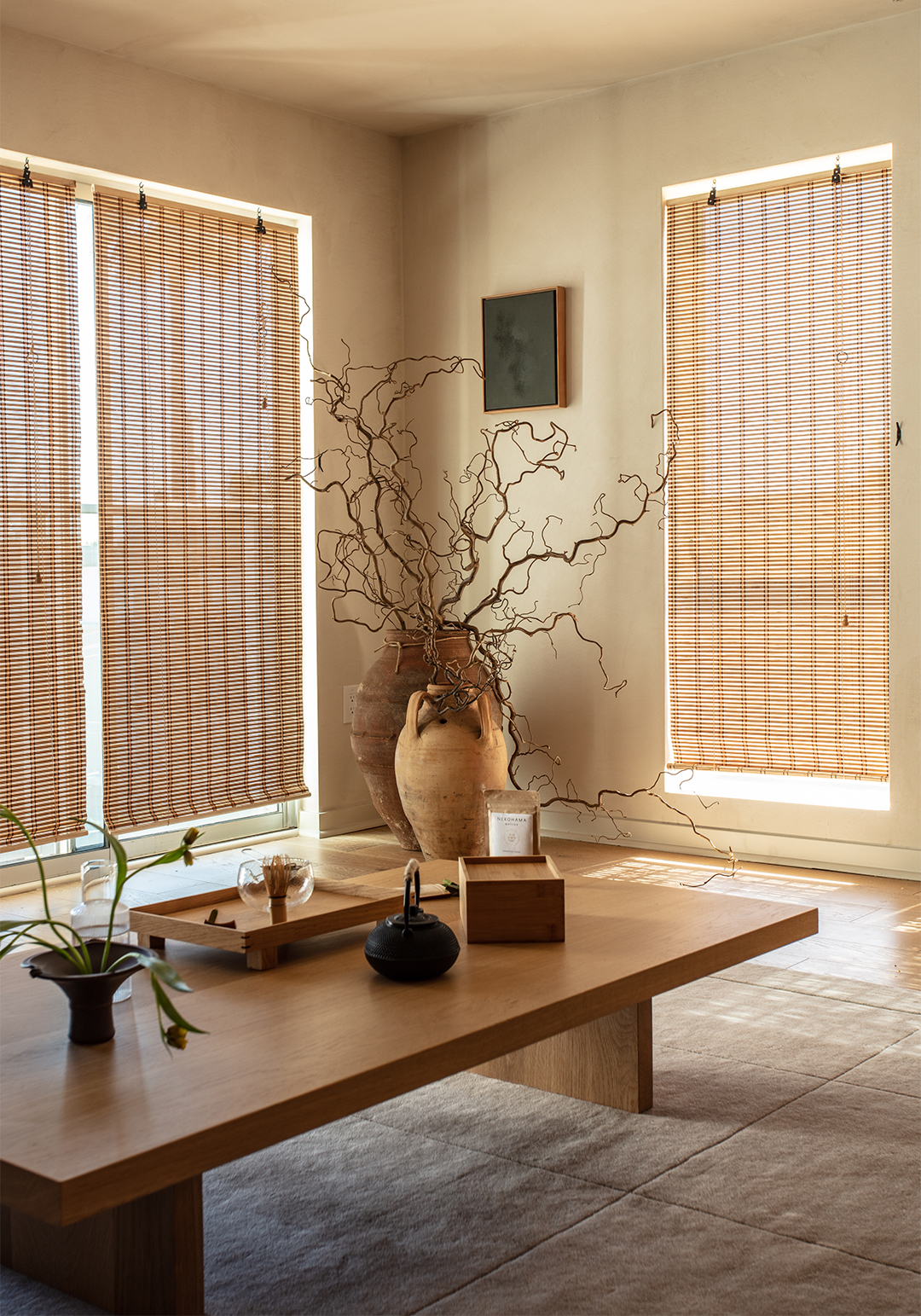 room with large terracotta vases and low dining table