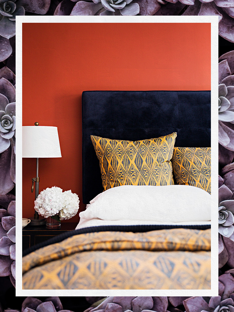 Bed with Blue Velvet headboard and yellow linens