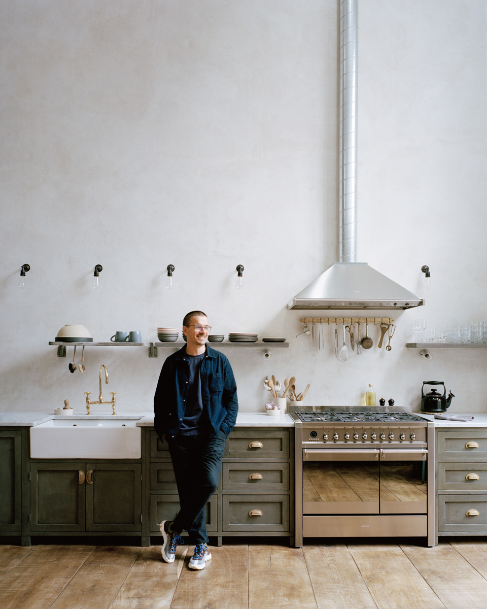 man leaning on kitchen cabinets