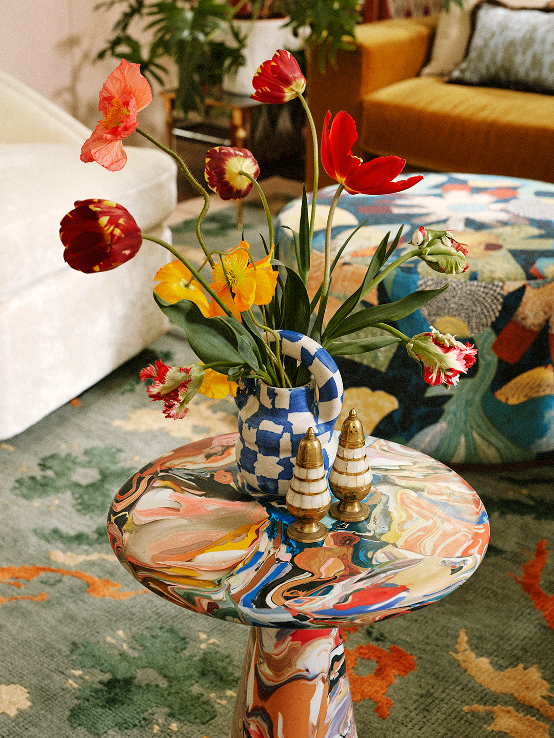 swirled accent table with blue ceramic vase