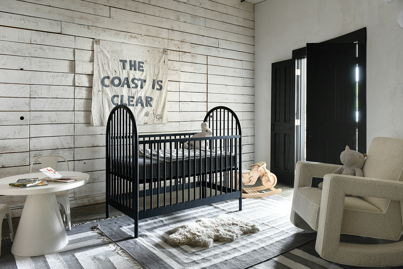 black crib in front of wood wall