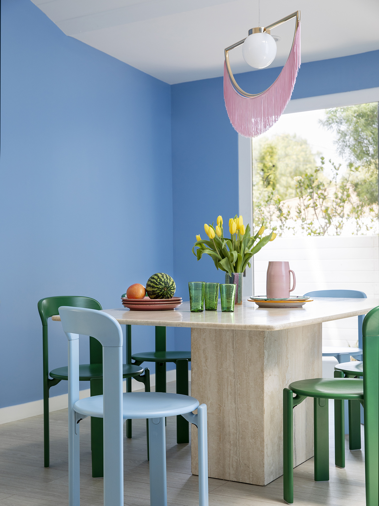 blue dining room with pink fringe pendant light