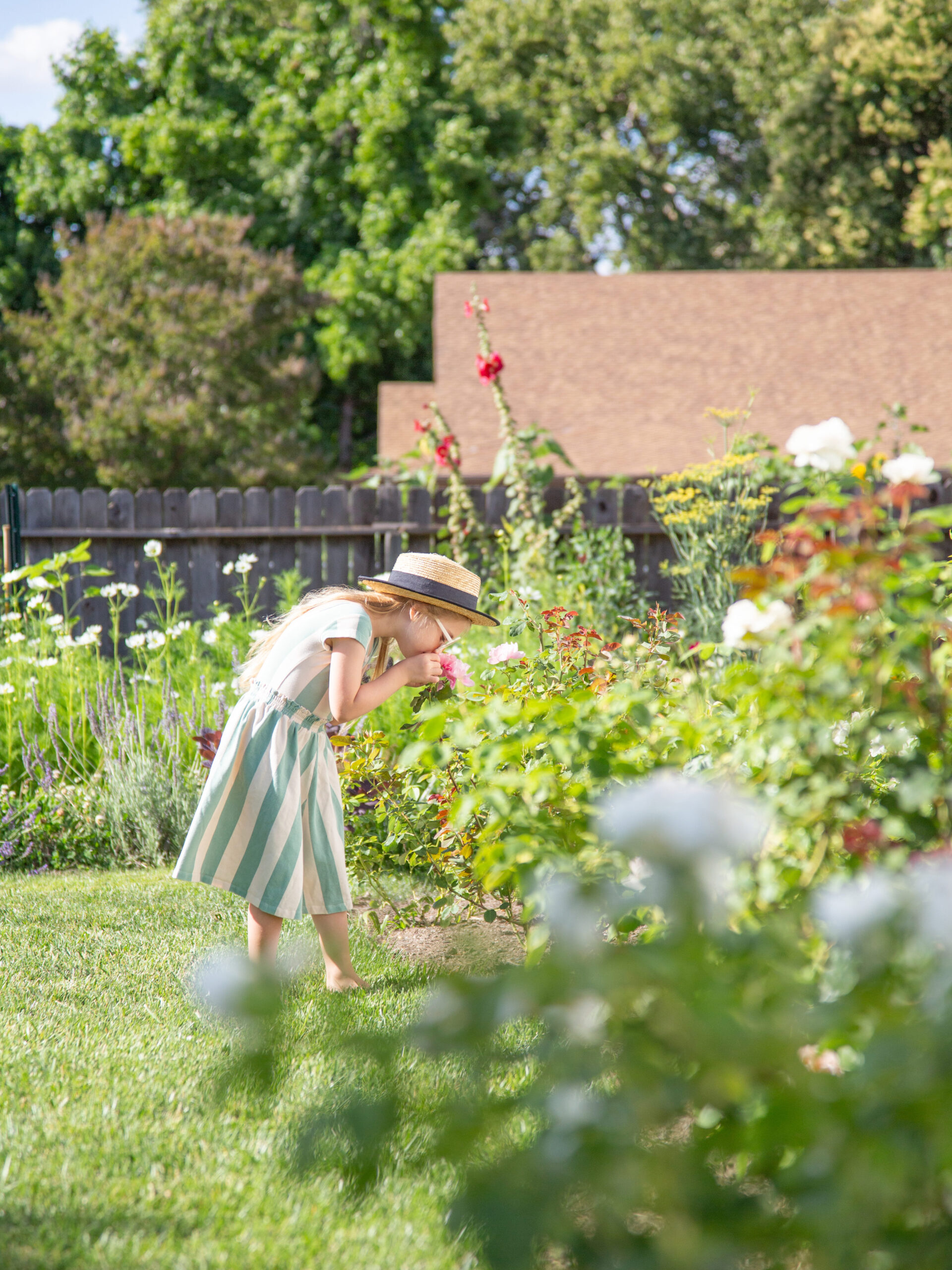 little girl smelling flowers