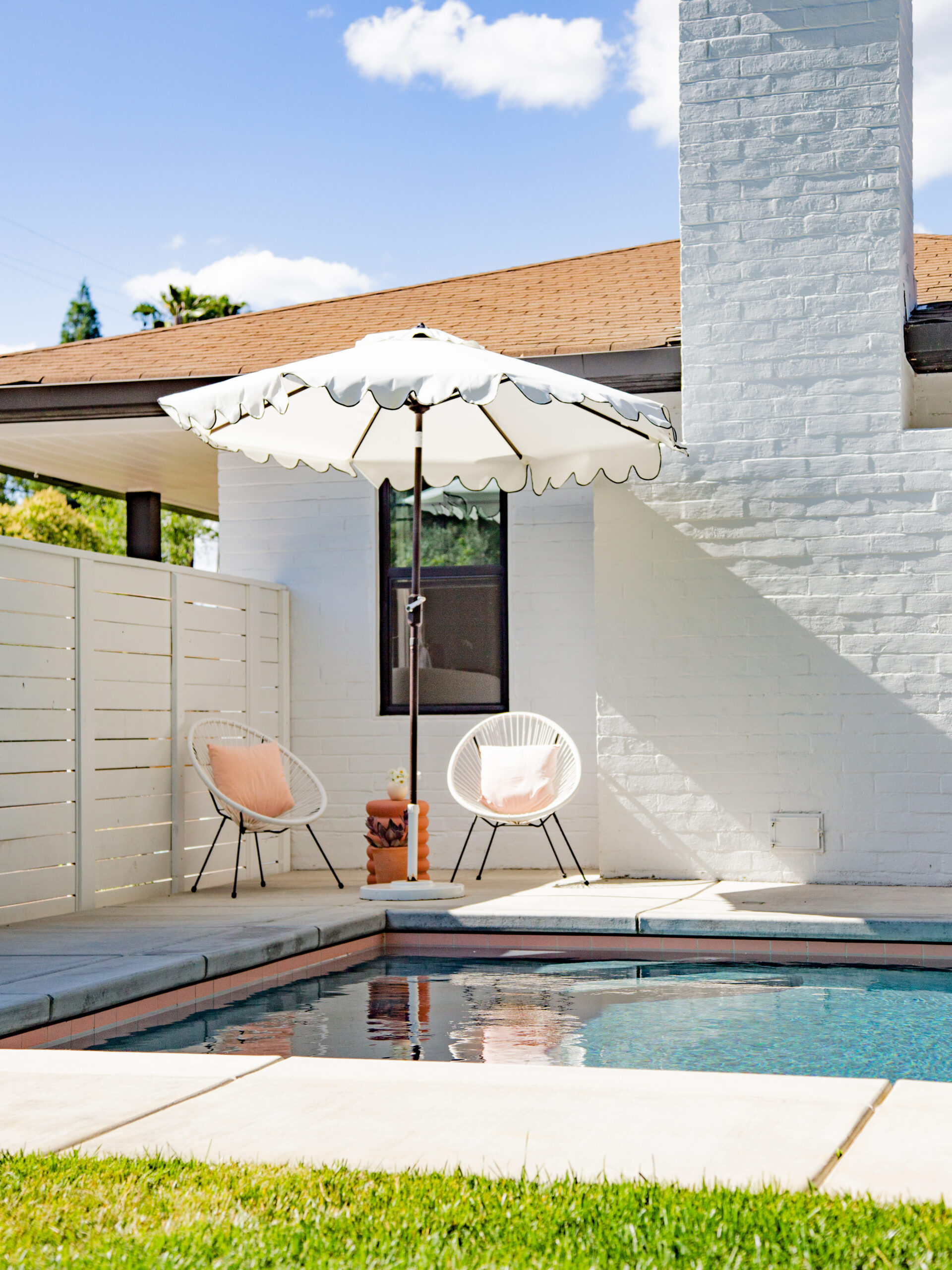 modern chairs in corner of pool