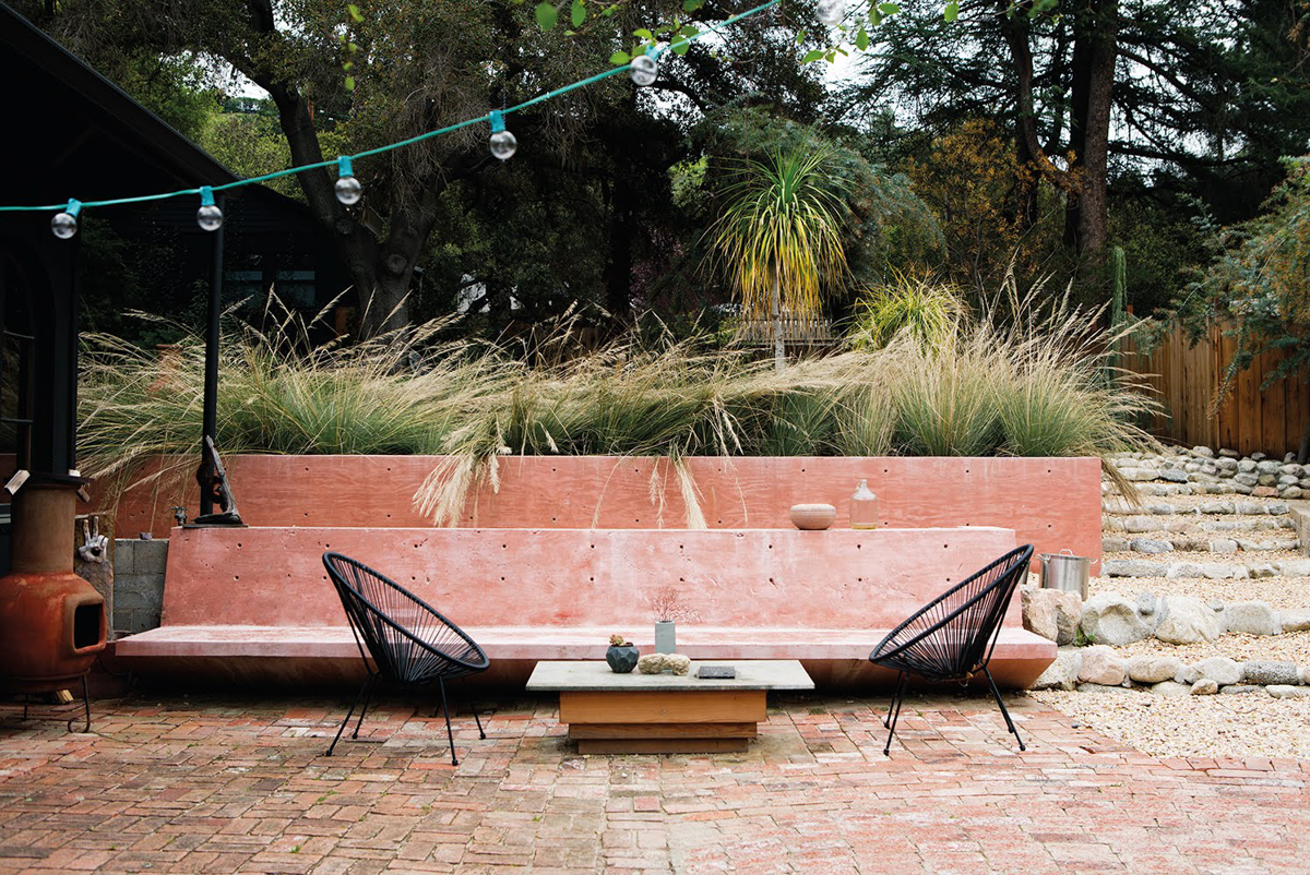 pink concrete bench with red brick pavers