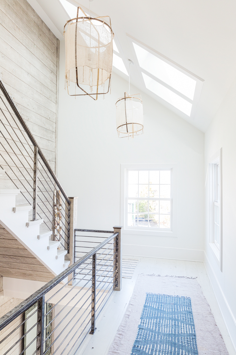 white stairway with layered runner rugs