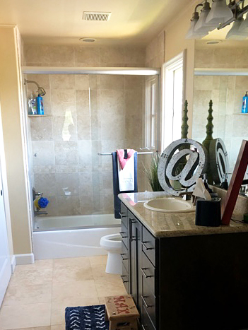 dated shower with beige tile