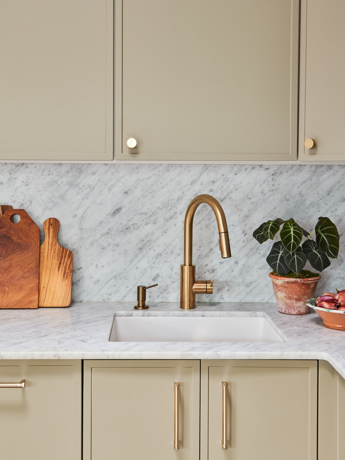 sage green cabinets over marble countertop