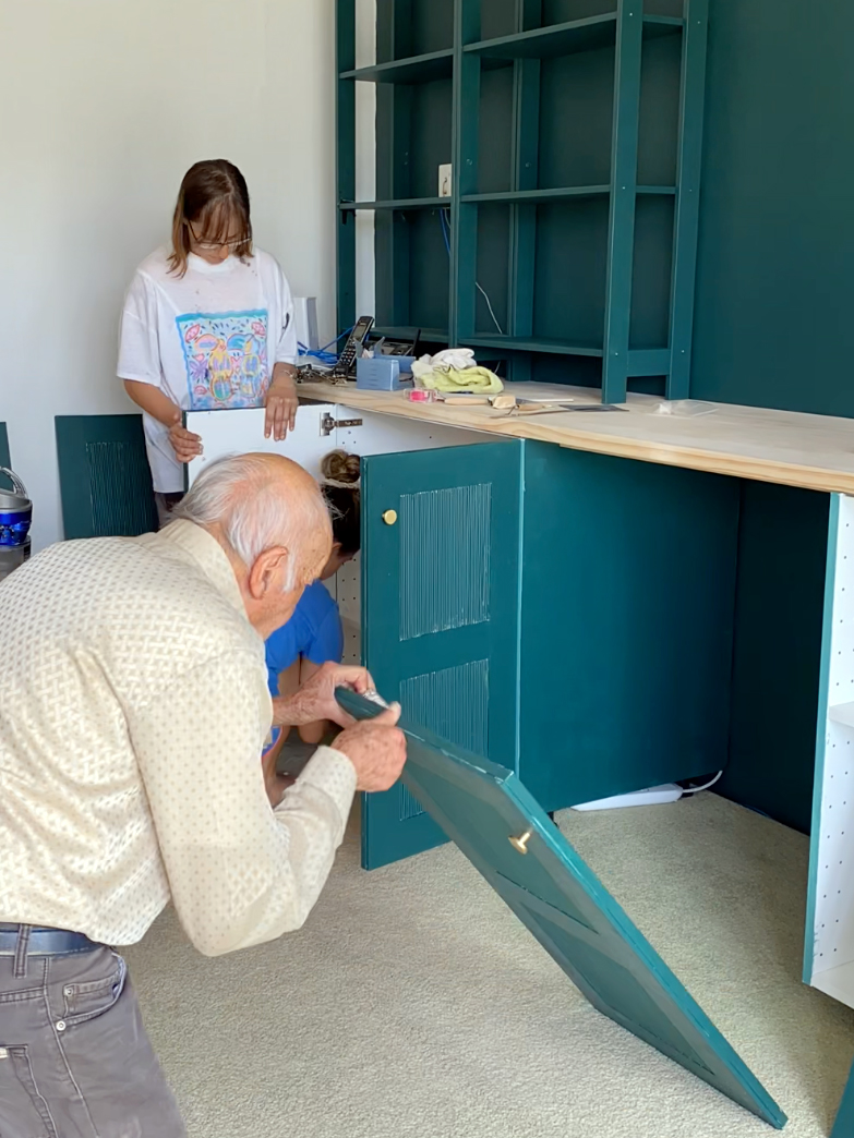 man assembling cabinet doors