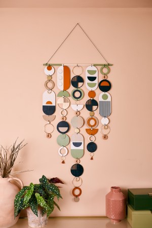 geometric wall hanging on pink background