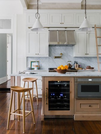 kitchen with marble island and wooden stools