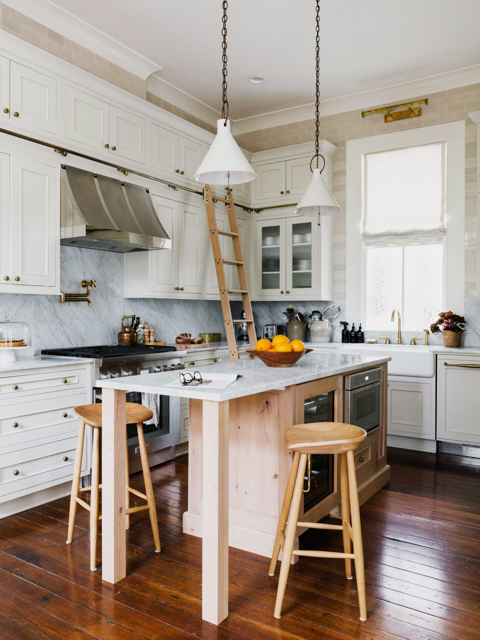 kitchen with white cabinetry and marble counters