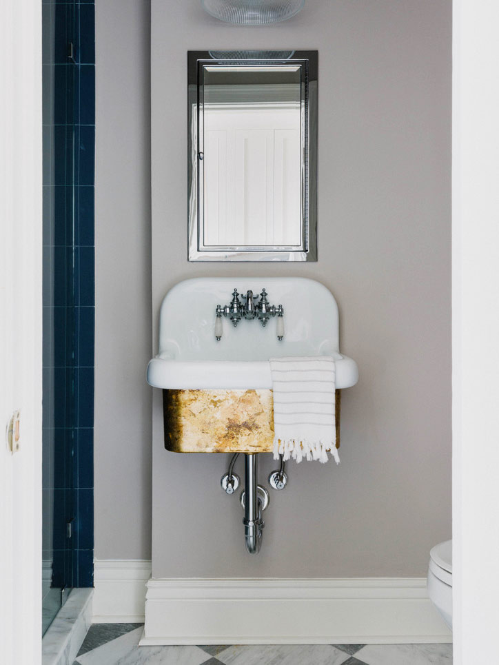 powder room with brass sink