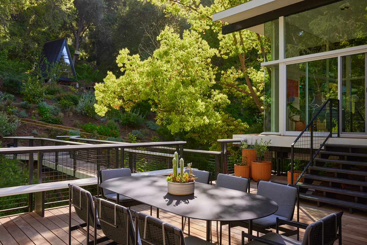 wooden deck surrounded by railing patio furniture