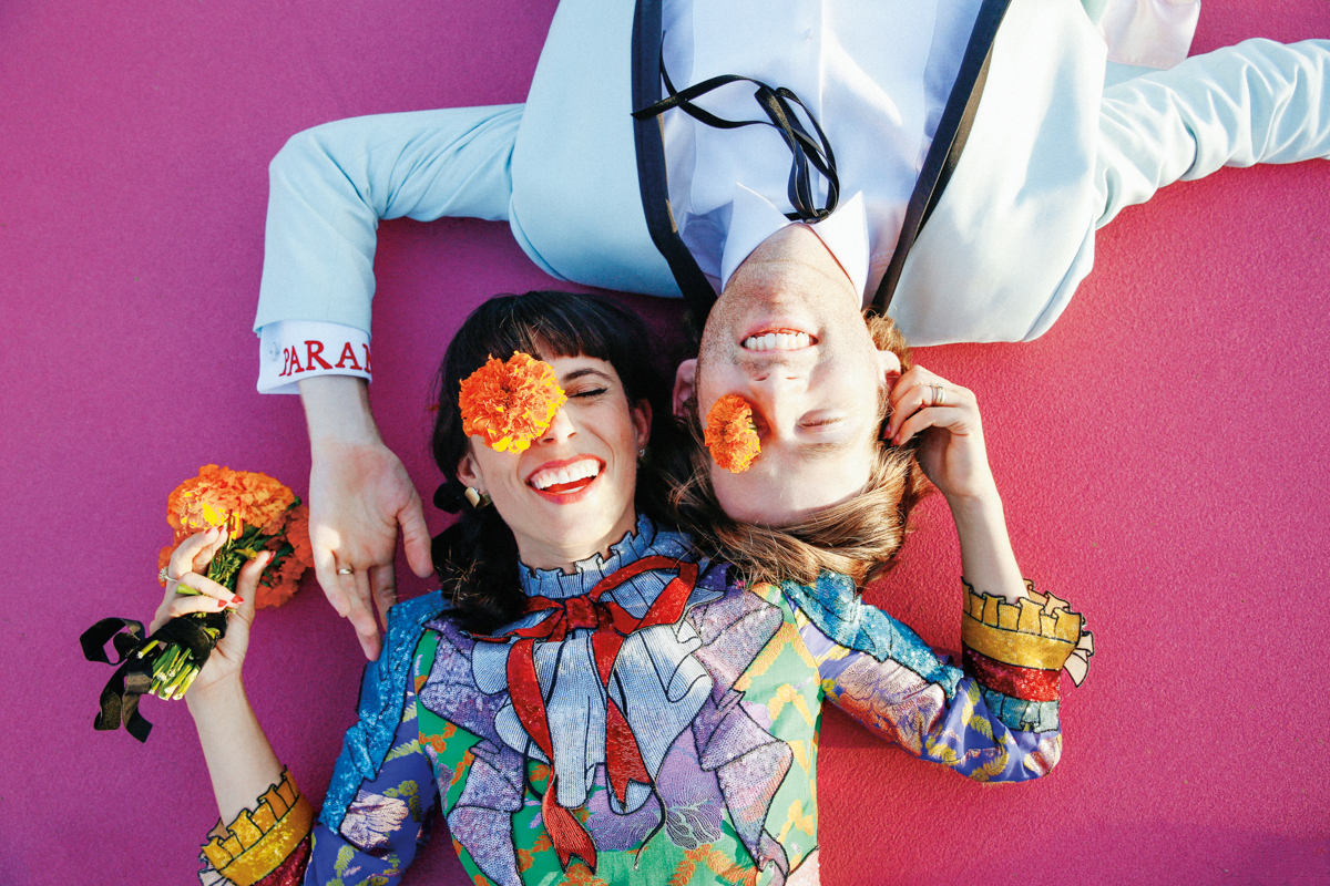 colorful couple smiling with flowers