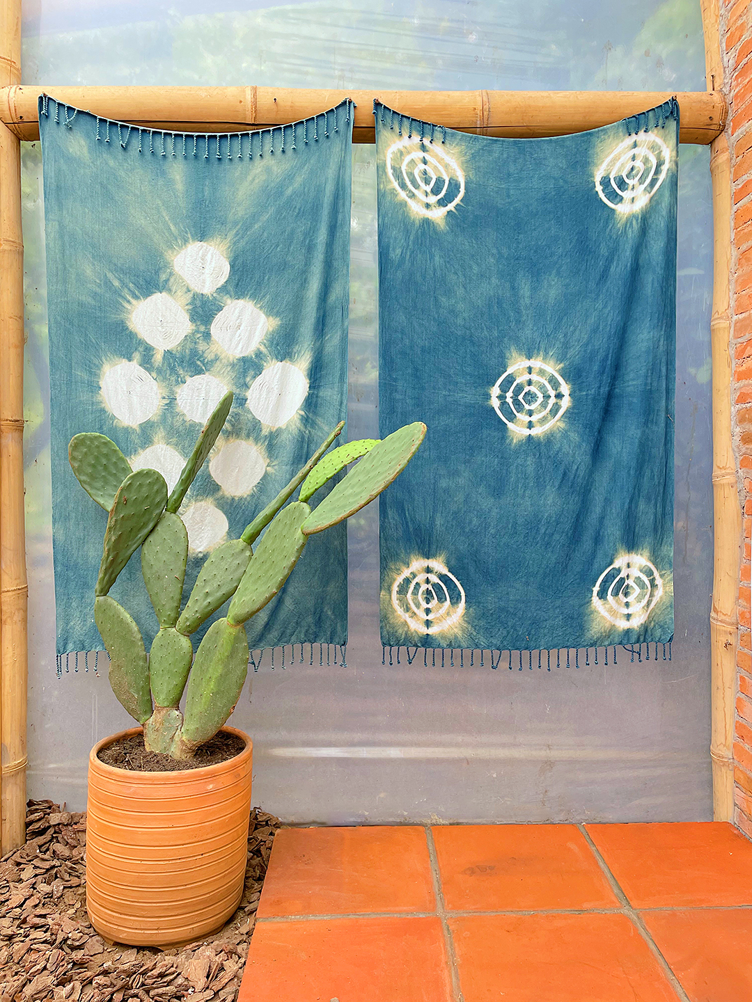 blue shibori dyed fabrics hanging on wall