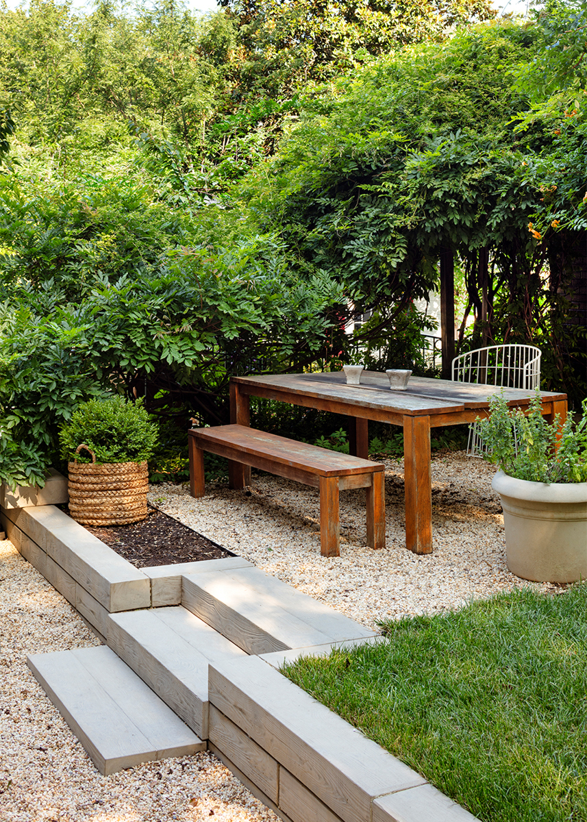 backyard patio with peastone gravel and concrete mini-staircase