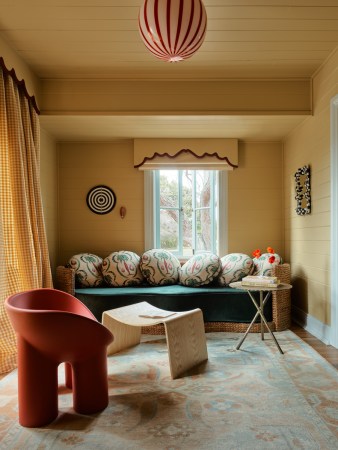 yellow living room with teal day bed