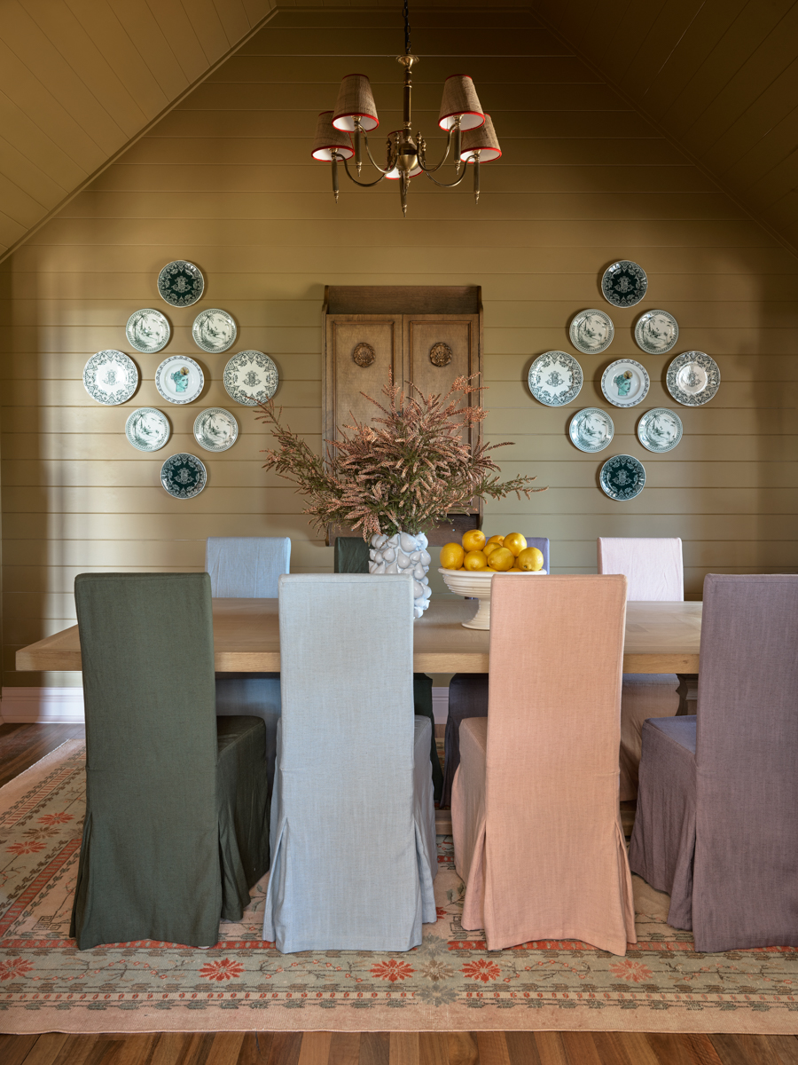 mustard yellow dining room with mismatched chairs