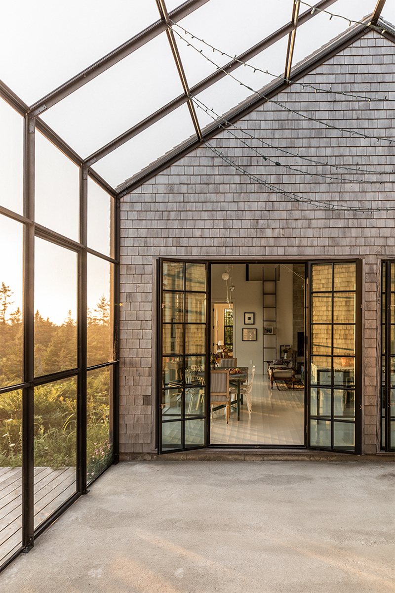 shingled home exterior with paneled screened in porch