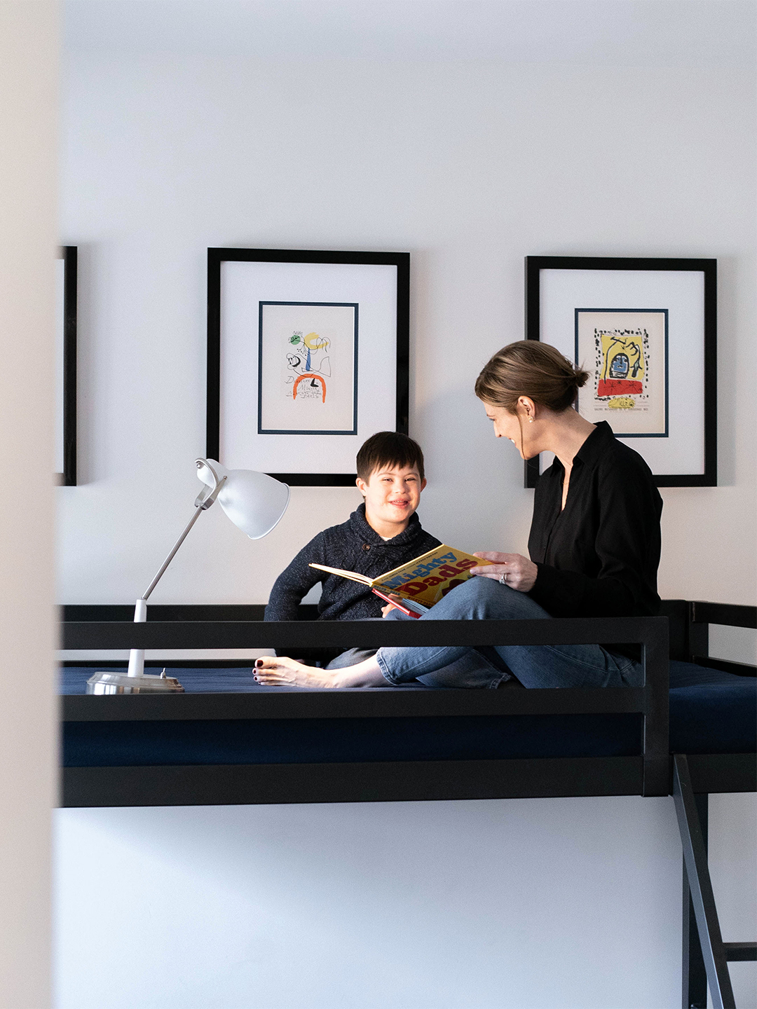 mother and child reading in top bunk with task lighting