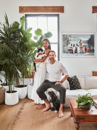 woman and man sitting with pets