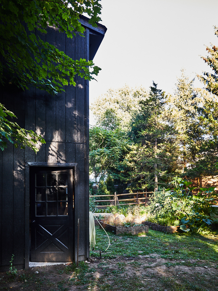 black home exterior and vegetable garden