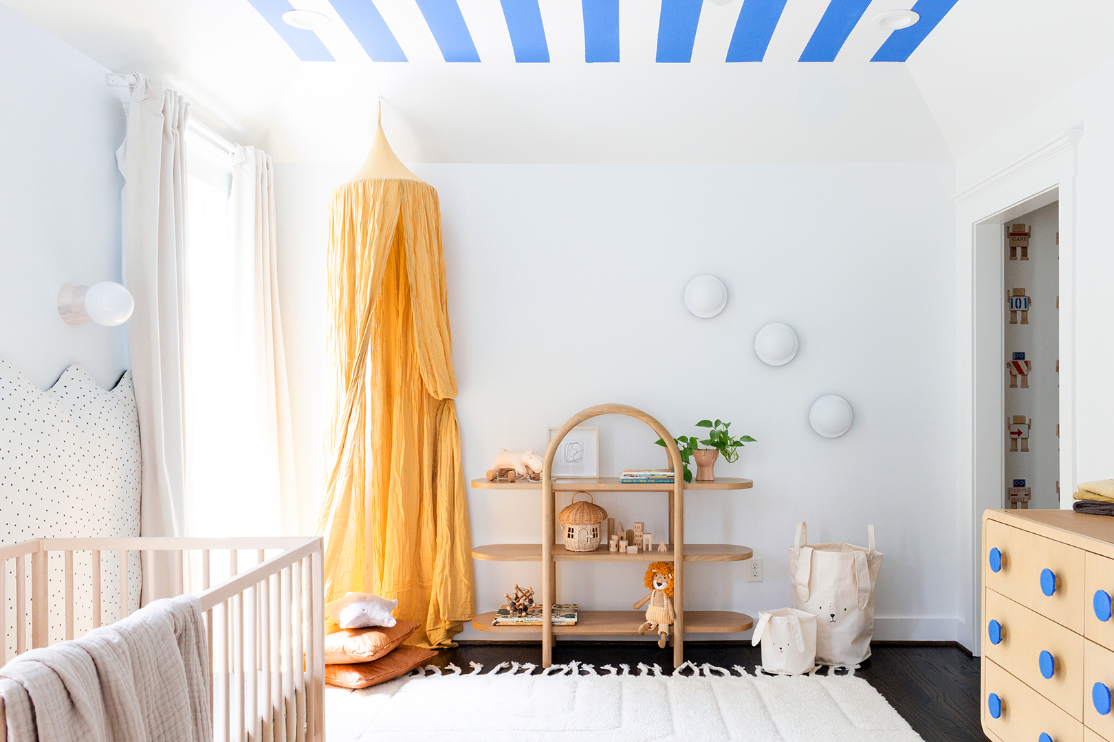 close-up of white nursery with blue-striped ceiling