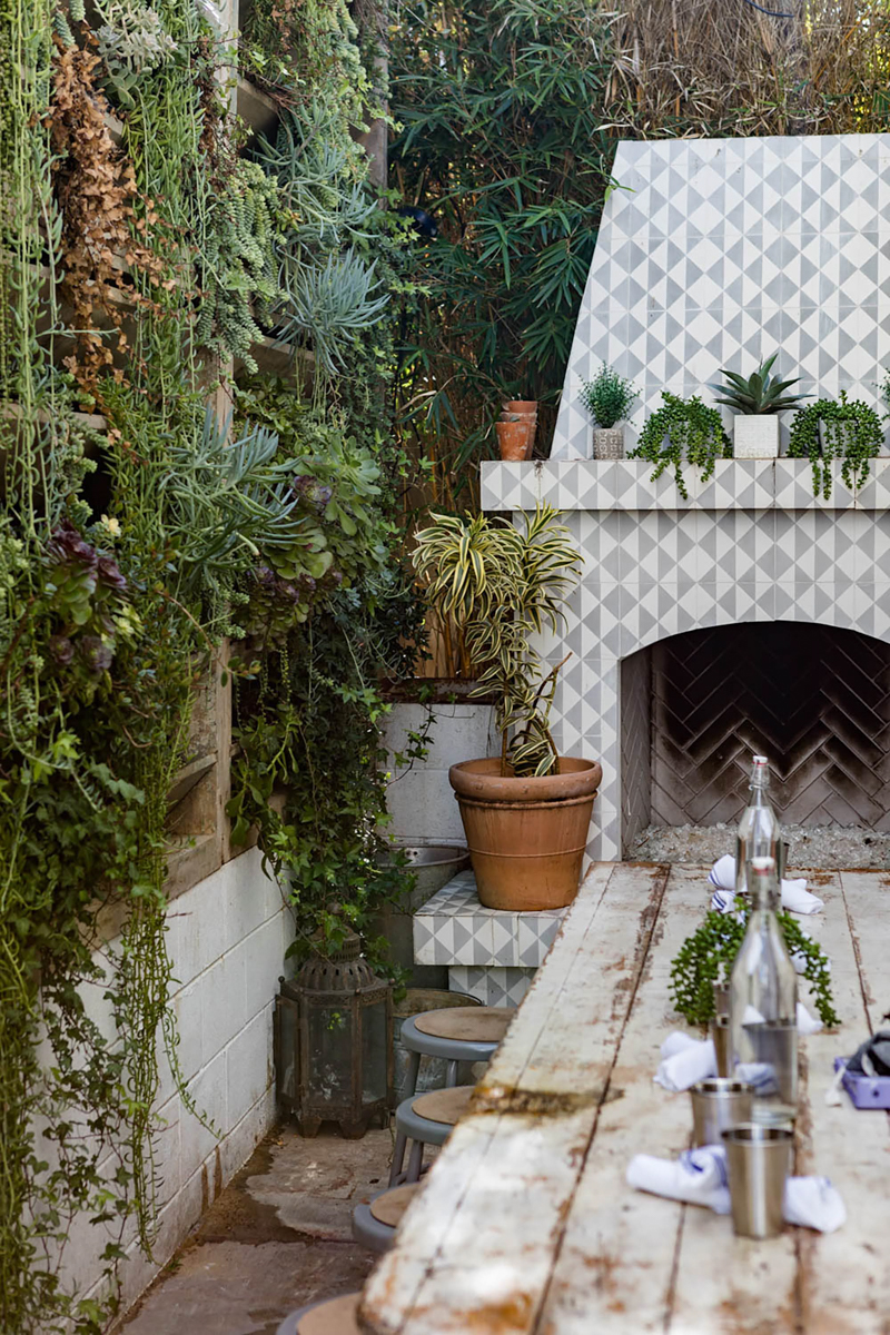 bungalow flagstone patio with bench and painted patterned fireplace