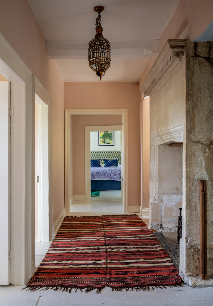 hallway with large stone fireplace