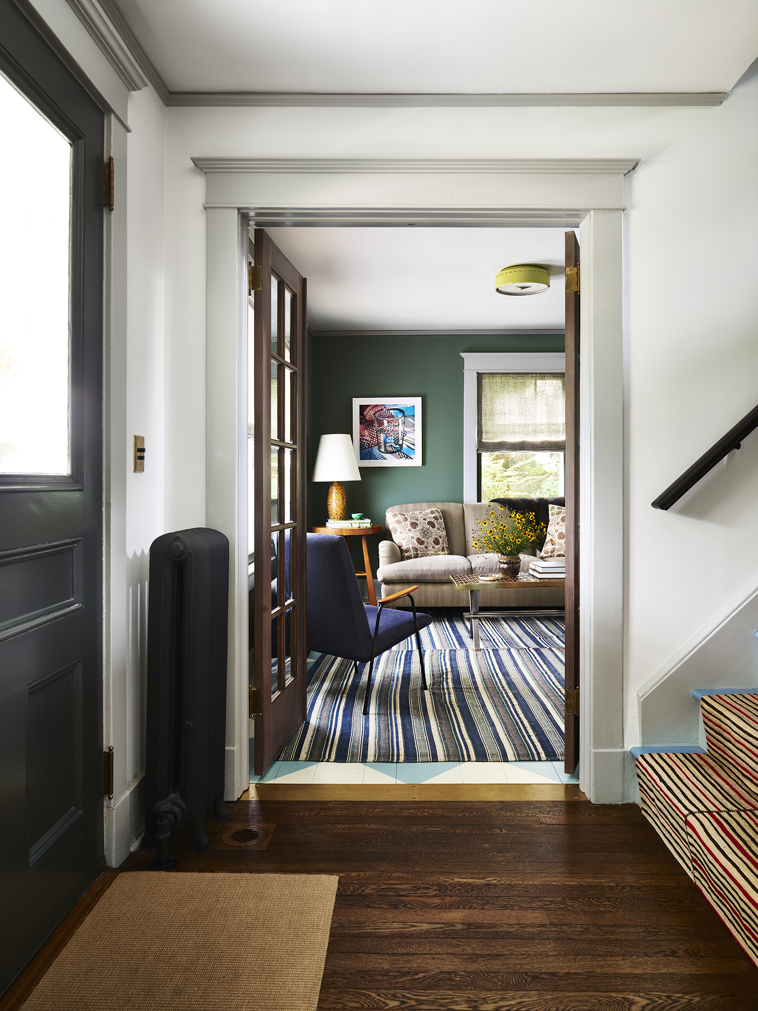 grey entryway with striped stair runner