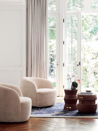 living room with white swivel seats.