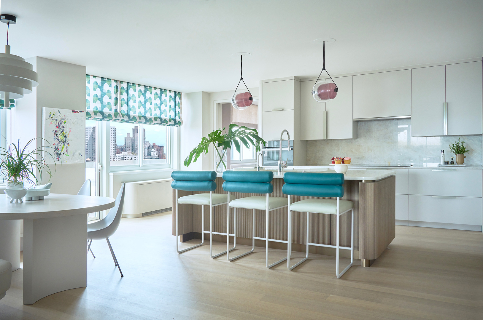 kitchen with white cabinetry and blue counter stools