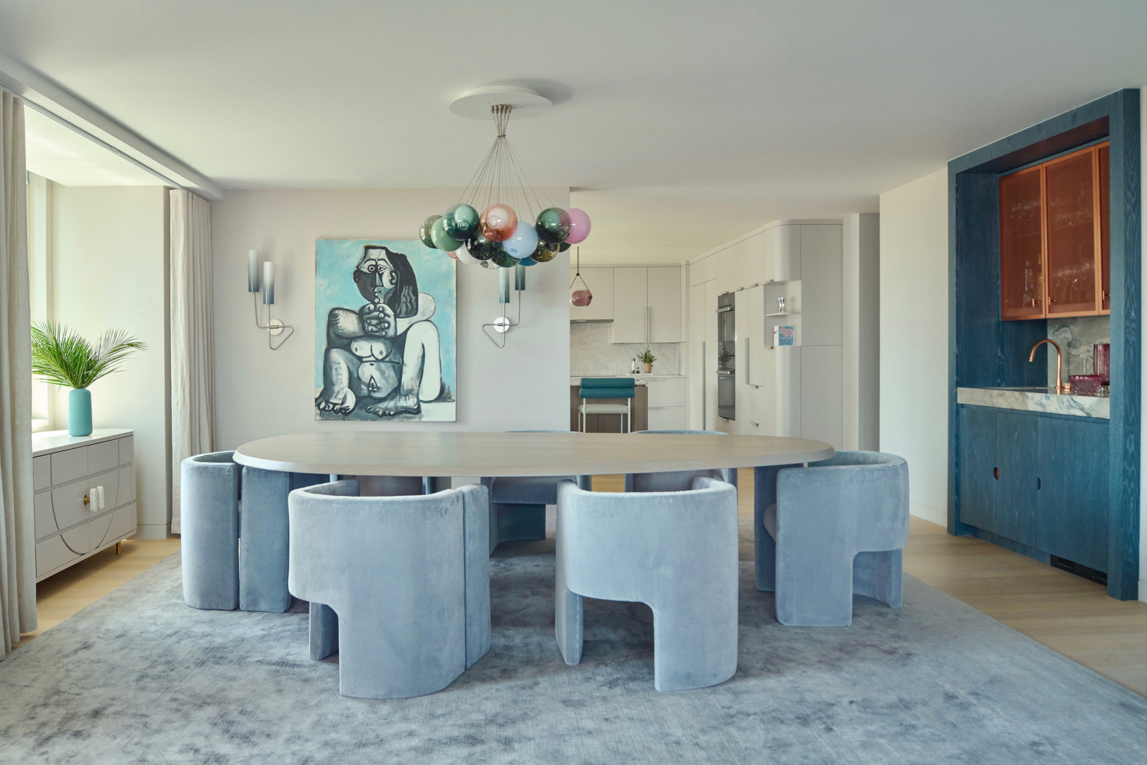 dining room with powder blue dining chairs and globe chandelier