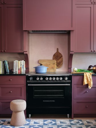 oxblood red kitchen cabinets and black range