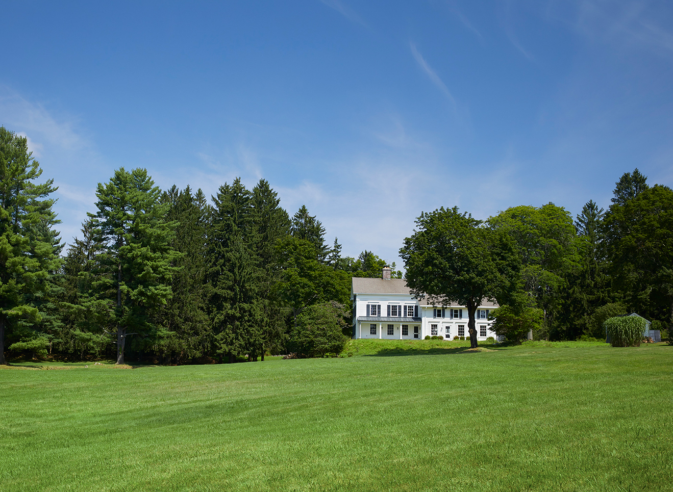 white farmhouse and surrounding land