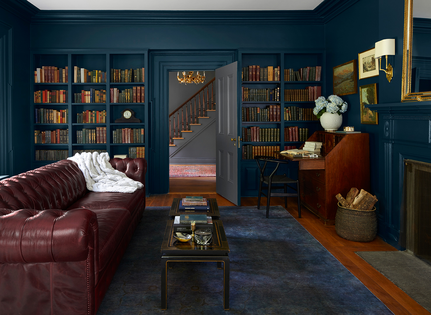 navy sitting room with leather chesterfield