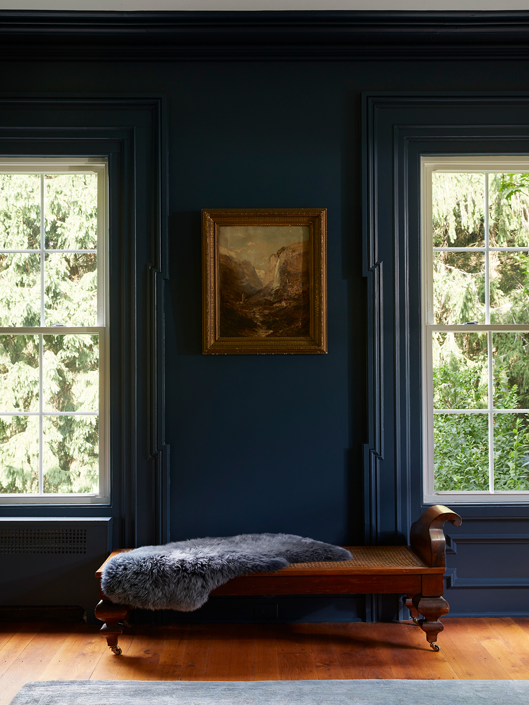 bench between two windows in navy sitting room