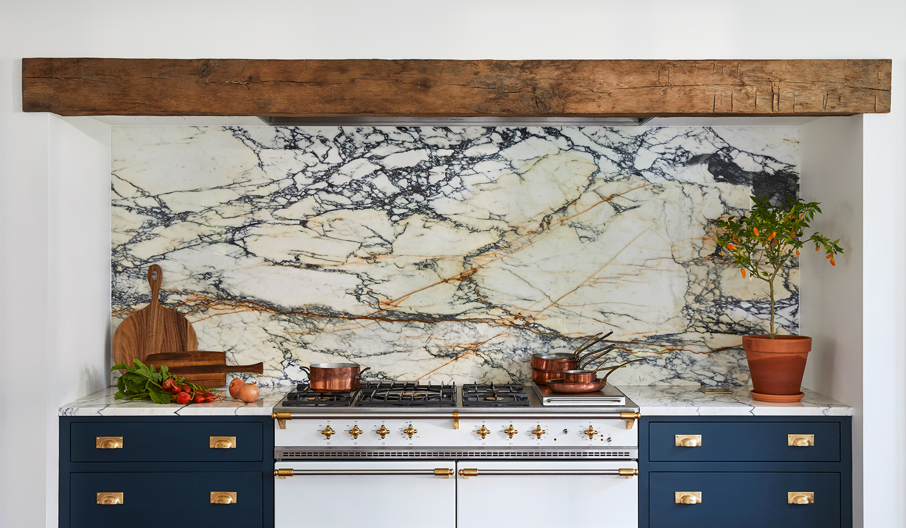 navy cabinets surrounding white kitchen range