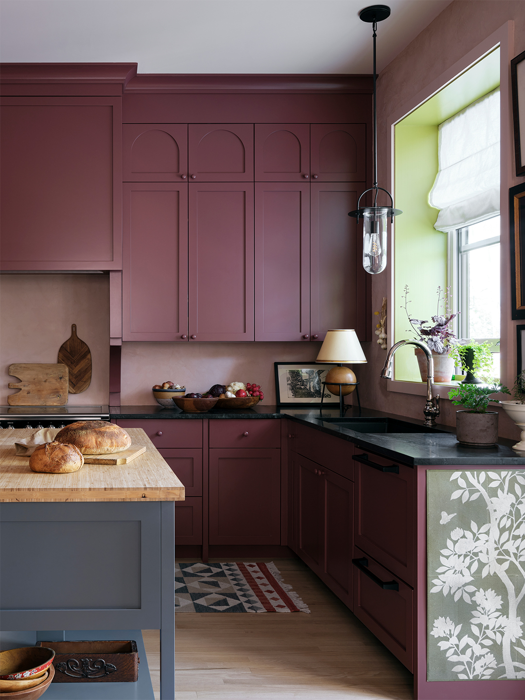 oxblood red kitchen with gray work table