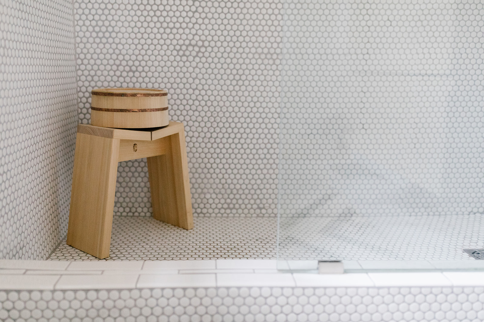 wood stool and bathing bucket in shower