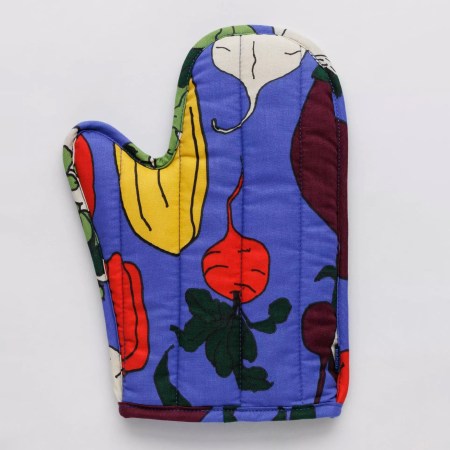  Periwinkle oven mitt with a colorful vegetable root print on a white surface.