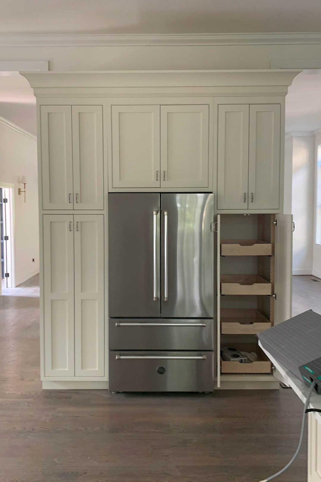 before refrigerator with white cabinets