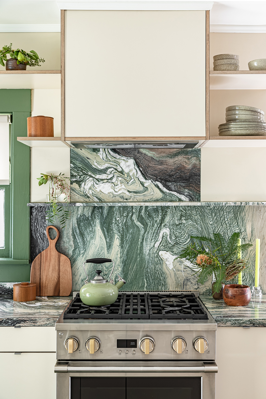 Kitchen stove with green marble backsplash