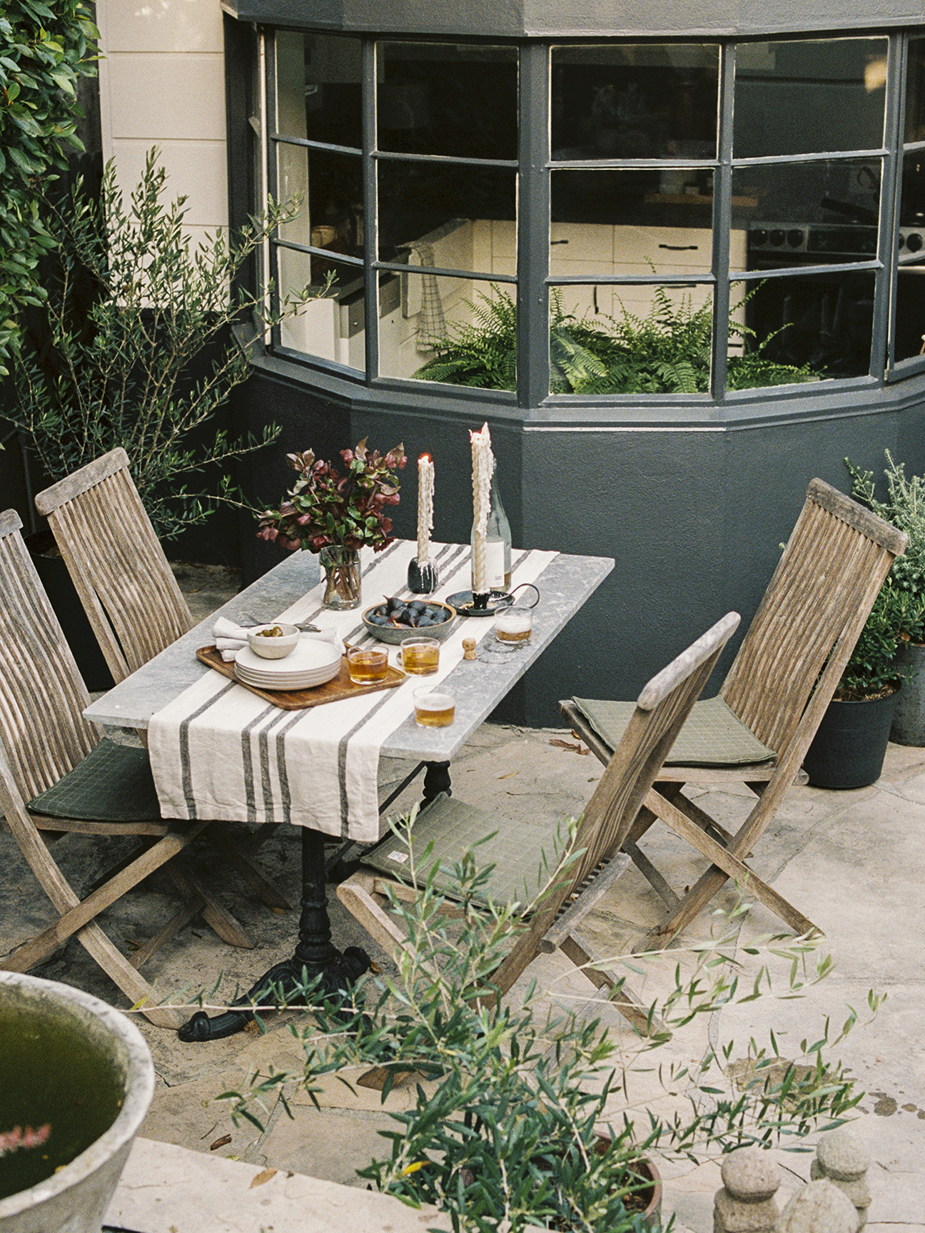 wood folding chairs at metal bistro table otuside