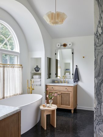 light-filled modern bathroom with floating tub